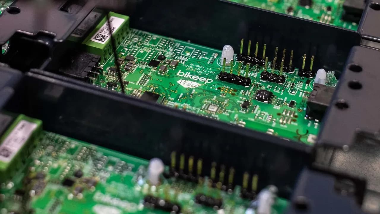 Bikeep circuit boards on the production line, with the Bikeep logo printed on a green PCB