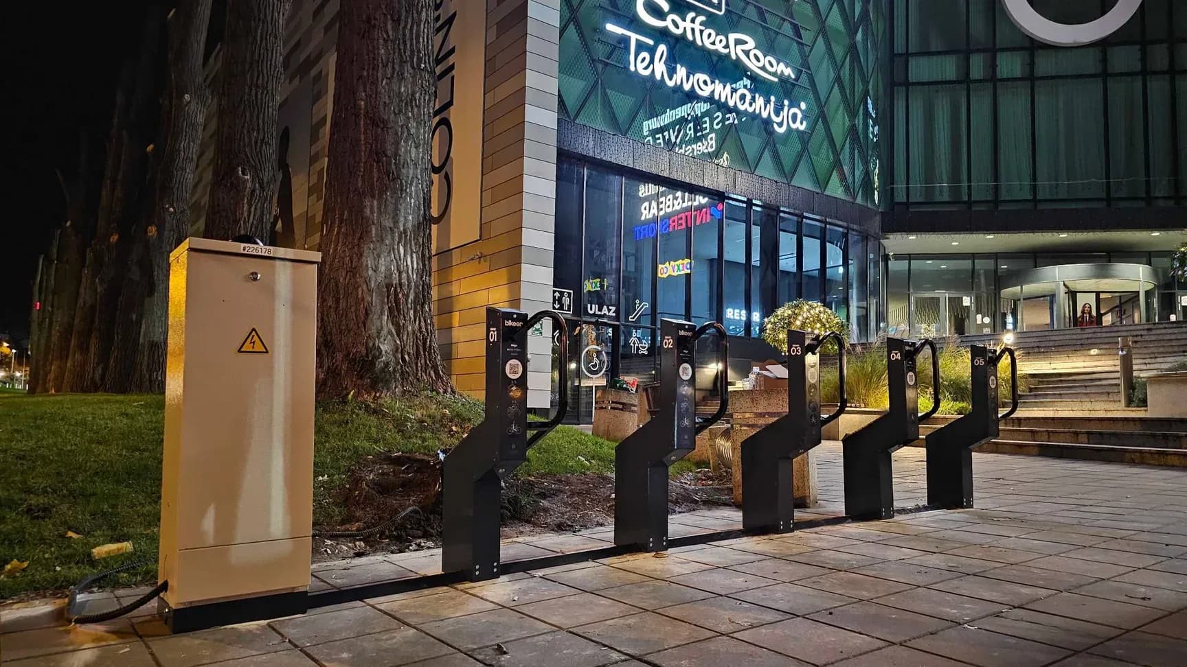 Five Bikeep docks and a charging cabinet outside the TC Beo shopping centre in Belgrade at night