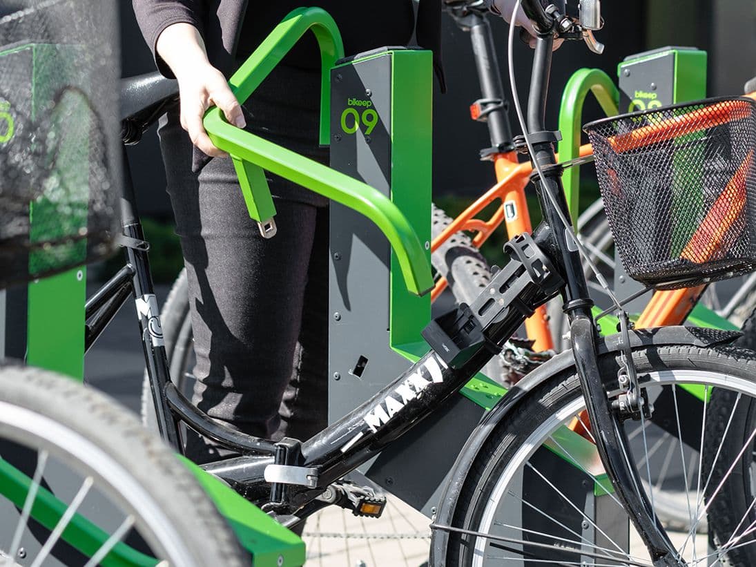 Bike being locked into a Bikeep dock by frame and wheel