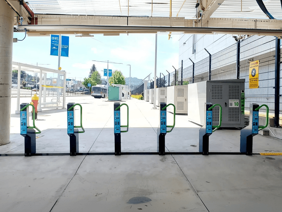 Smart bike docks and smart bike lockers side by side at a transit station
