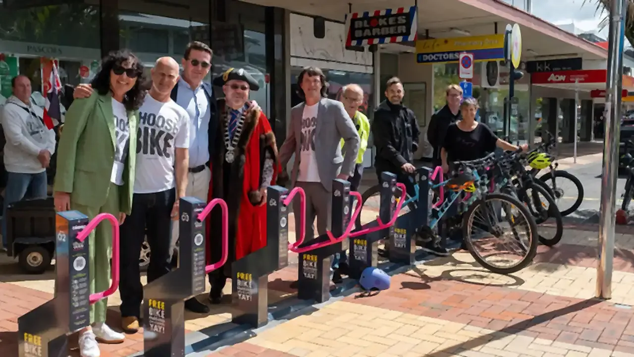 Supporters and the mayor gather at a new Locky Dock bike parking station on a town-center shopping street in New Zealand