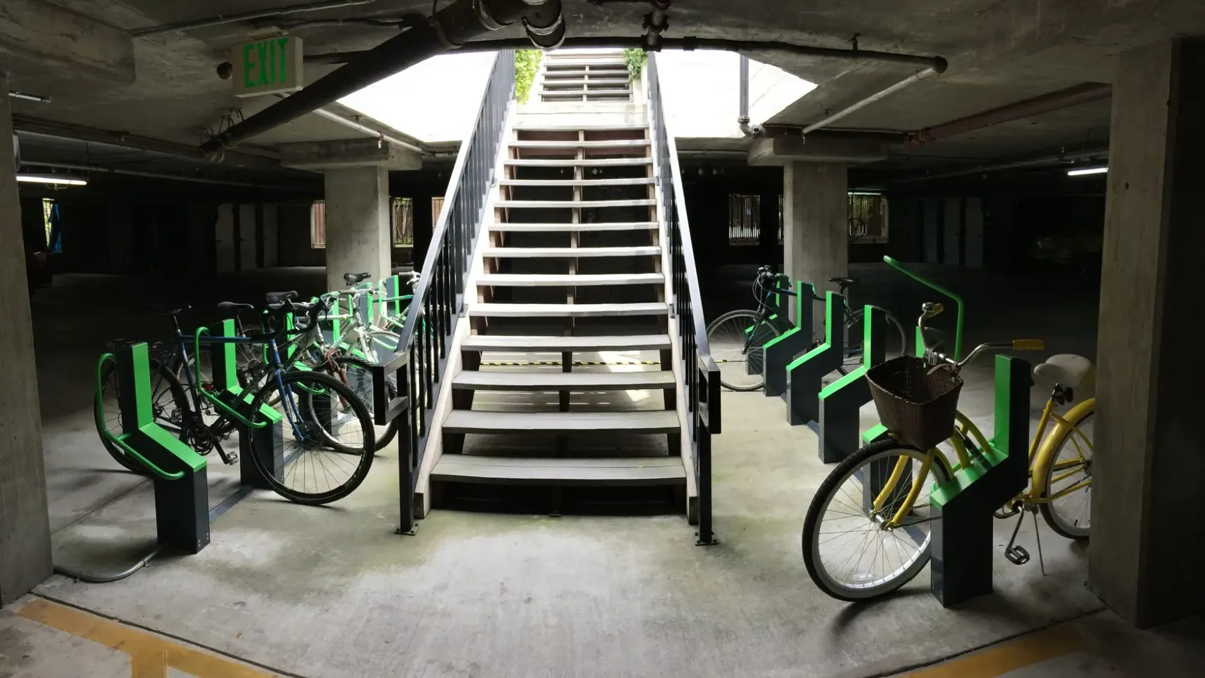 Bikeep smart bike parking docks on both sides of a stairway in the Cam Properties underground garage in Menlo Park, California