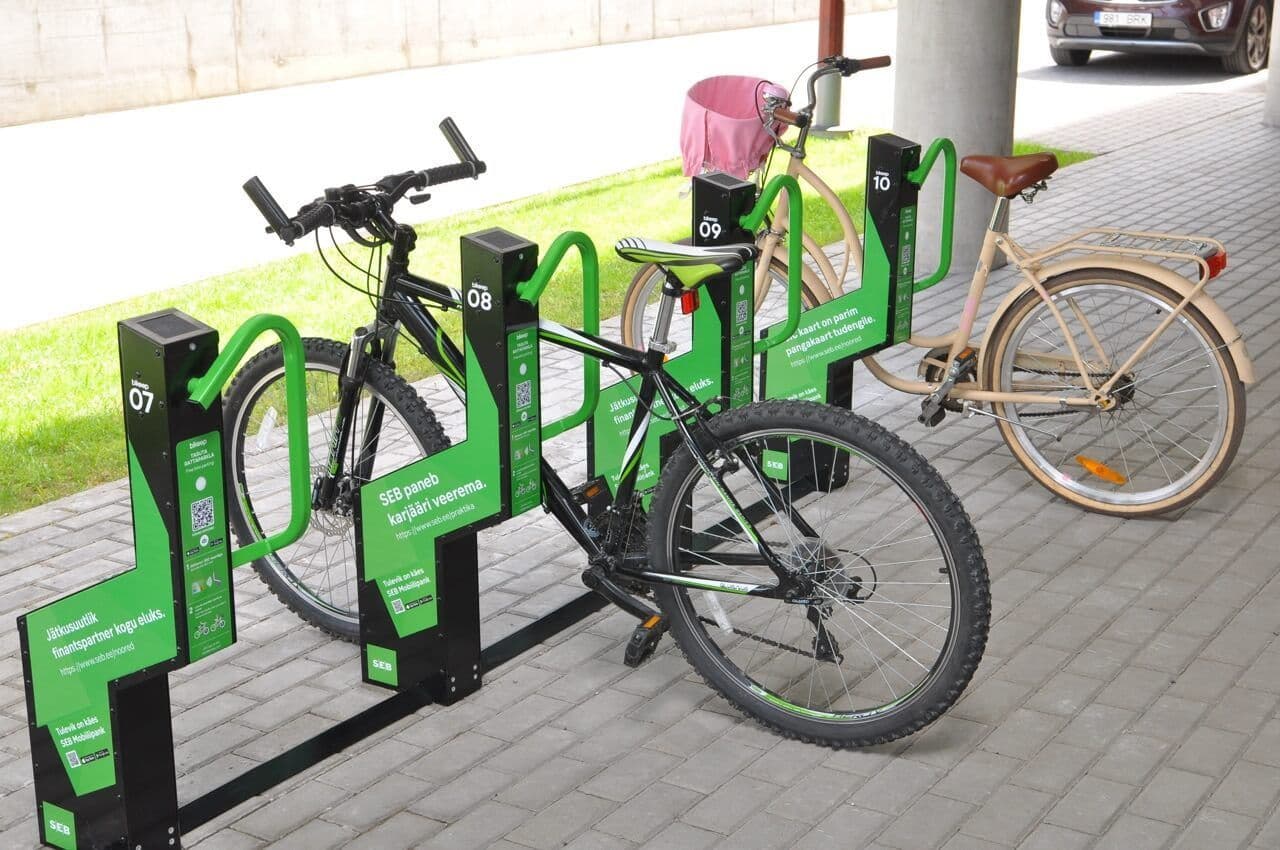 Bikes parked at a green co-branded Bikeep smart bike parking station